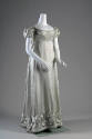 Pale aqua blue dress with pleated motifs on bodice above empire waist and folded motifs on shor…