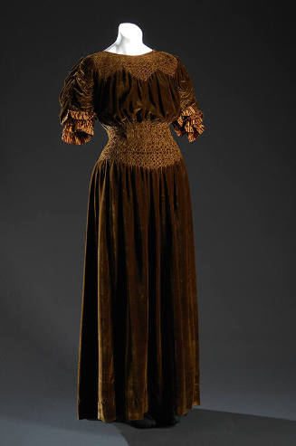 Bown velvet floor length dress with smocked neckline and waist, gathered 3/4 sleeves with silk …