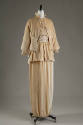 Beige velvet eight button cutaway jacket, lace top, matching floor length draped skirt with dou…