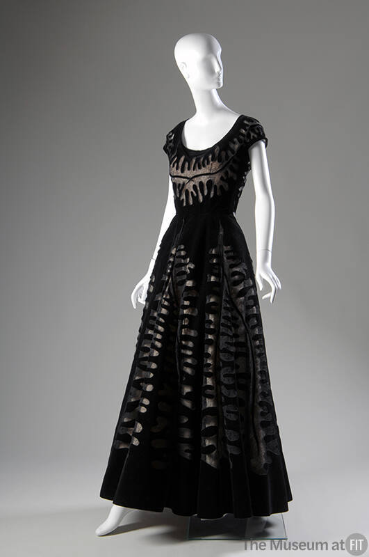 Black floor length evening gown with large cut-outs inset with black lace, cap sleeves and flar…