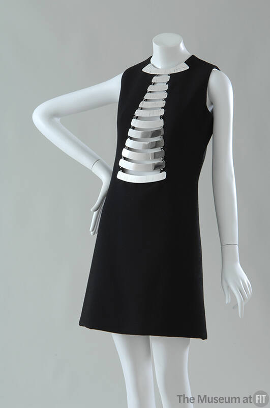 Black sleeveless mini dress with silver metal breast plates