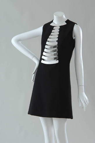 Black sleeveless mini dress with silver metal breast plates