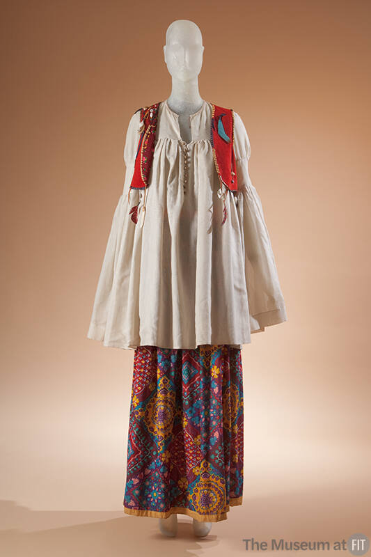 Off-white long sleeve tunic top with cropped red vest with embroidery and purple, yellow, blue …