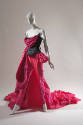 Black corset with pink silk draped swags, peplum and long train over pink pants 