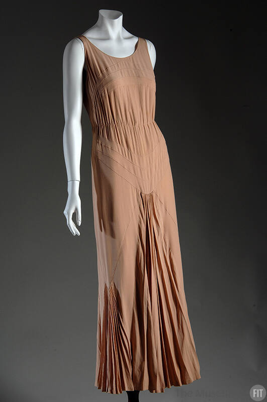 Light brown sleeveless scoop neck evening dress with gathering at waist and seaming to create V…