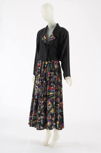 Black long sleeve jacket with multi-color lapels and ankle-length skirt with allover geometric …