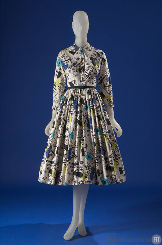 White long sleeve button front shirt dress printed with blue, black and green parade design, fu…