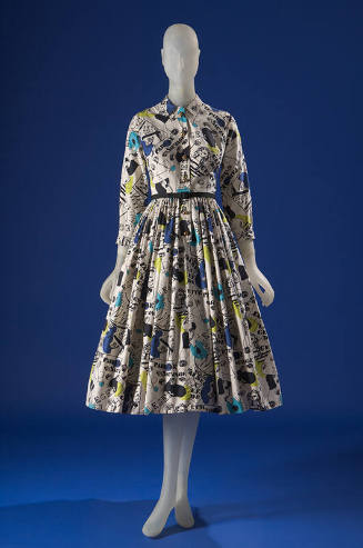 White long sleeve button front shirt dress printed with blue, black and green parade design, fu…