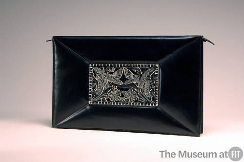 Black leather rectangular clutch bag with floral ornament in center
