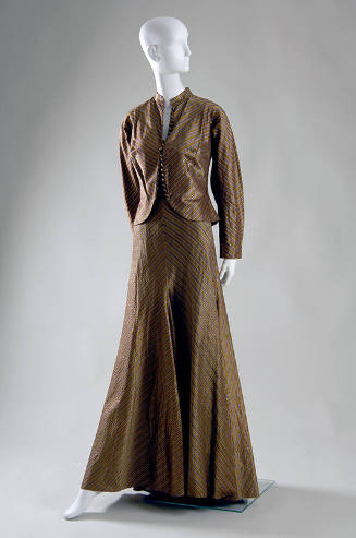 Floor length evening dress in gold, grey, brown and yellow striped silk meeting at center seam …