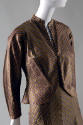 Detail view of gold striped jacket with deep V-neck and inverted stripe pattern contrasting wit…