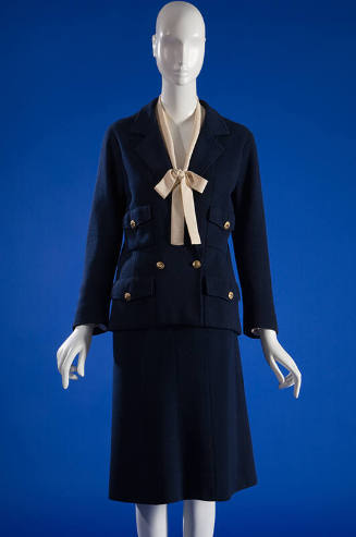 Blue wool double breasted suit jacket with gold buttons, off-white bow tie top and blue knee le…