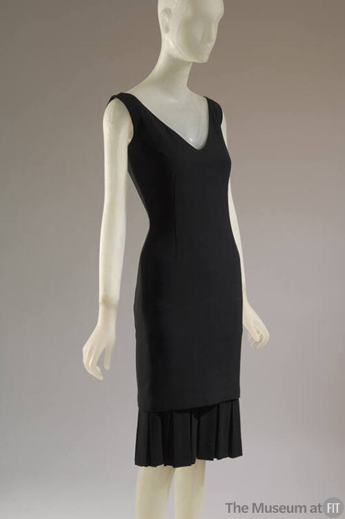 Black V-neck sheath dress with box pleated flounce at hem