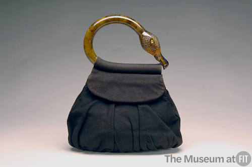 Dark brown suede pouch handbag with tortoise shell flamingo head and neck shaped handle