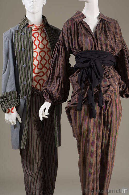 Left: Grey, green, black striped jacket, orange and white squiggle design top, grey, black and …