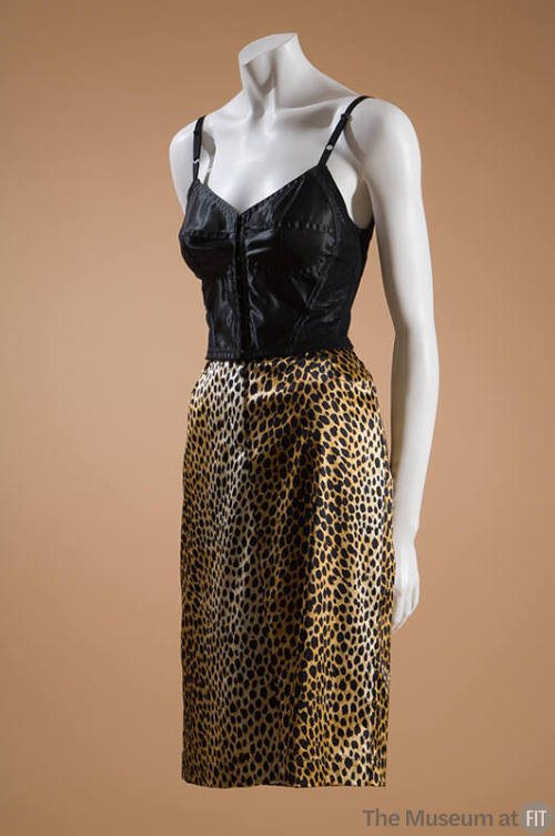 Black longline bra styled bustier with molded cups and seaming dressed with below knee length l…