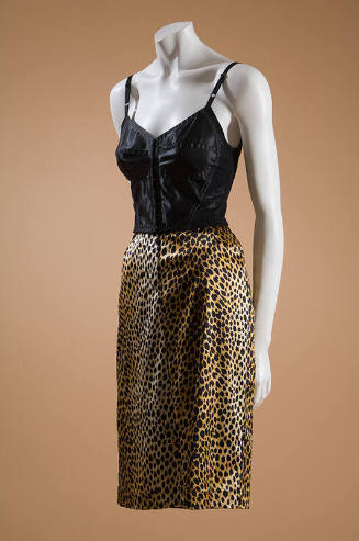 Black longline bra styled bustier with molded cups and seaming dressed with below knee length l…