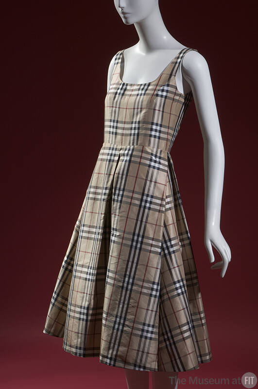 Tan, red, black, and white plaid sleeveless tank dress with below the knee flare skirt and four…