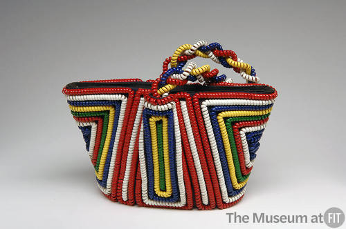 Small tote bag with red, white, blue, yellow, and green coiled telephone cord in symmetrical ge…