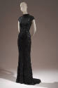 Long black evening dress encursted with tiny black sequins; mock turtleneck and cap sleeve
