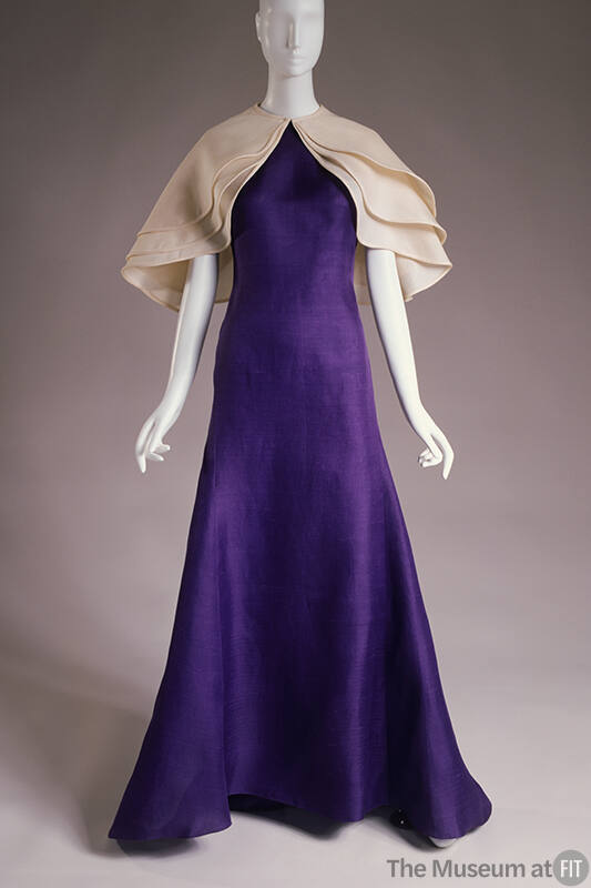 Purple floor length gown with triple layered off-white capelet 