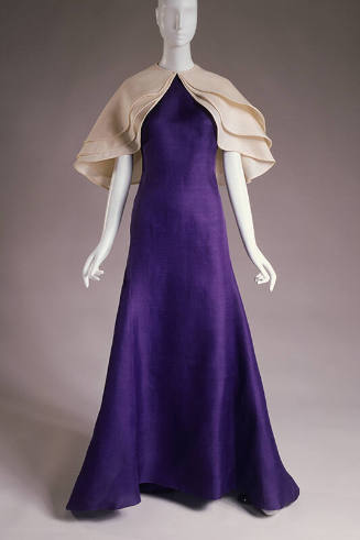 Purple floor length gown with triple layered off-white capelet 