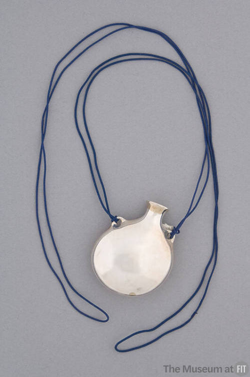 Necklace of large silver open round bottle pendant with dark blue cord strung through handles