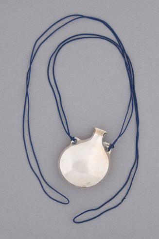 Necklace of large silver open round bottle pendant with dark blue cord strung through handles