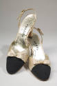 Pair of cream satin slingback shoes with black toe cap, small bow on vamp, high heel and Chanel…
