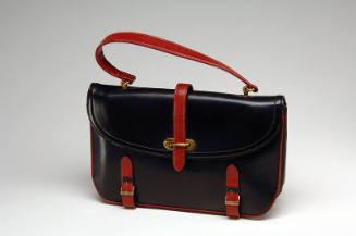 Black satchel style handbag with red handle and straps