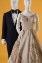 Man's navy blue and black evening suit with bowtie, champagne cream evening gown with star deta…
