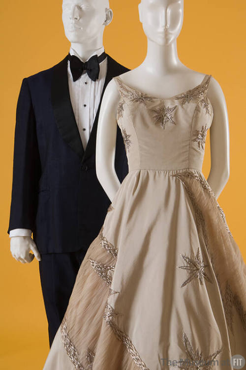 Man's navy blue and black evening suit with bowtie, champagne cream evening gown with star deta…