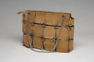 Purse comprising of tan suede squares with white metal eyelets and silver chain straps