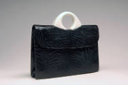 Black envelope, lizard skin bag with small round white plastic handle