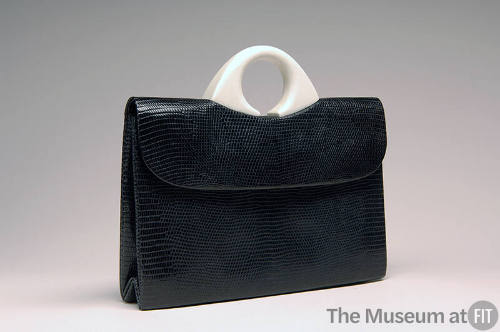 Black envelope, lizard skin bag with small round white plastic handle
