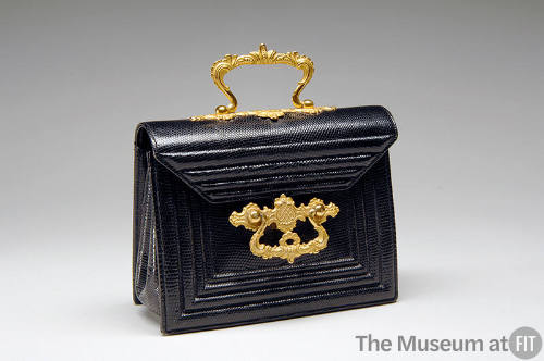 Small black lizard rectangular handbag with gold clasp ornament and top handle