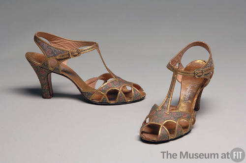 T-strap open toe high heel shoes with green and red floral pattern and gold trim