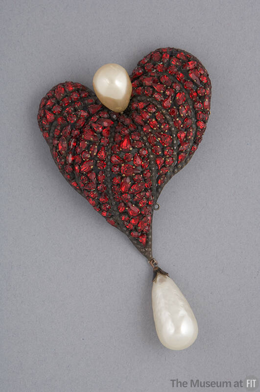 Large asymmetrical heart shaped brooch with red rhinestones and large baroque pearl at top and …