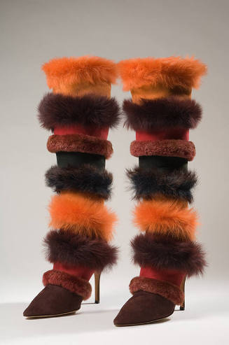 Pair of stiletto boots with alternating horizontal bands of suede and fur in red, orange and da…