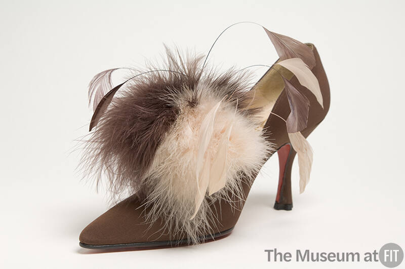 Brown high heel pump with brown and beige feathers and quills on vamp and pointed toe