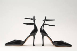 Pair of black d'Orsay shoes with double ankle straps attached to high counter, high stiletto he…