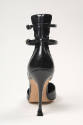 Rear view of black d'Orsay shoe showing ankle straps attached to high counter and high stiletto…