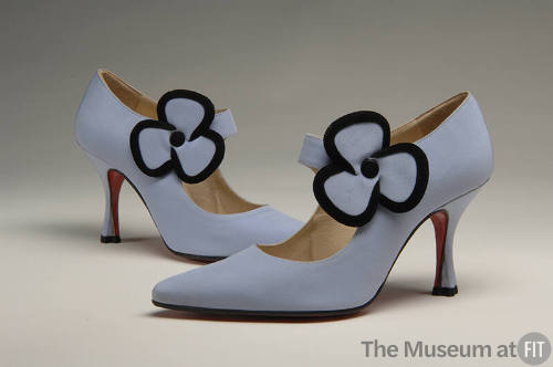 Pale purple high heel shoes with large flower at ankle strap lined in black