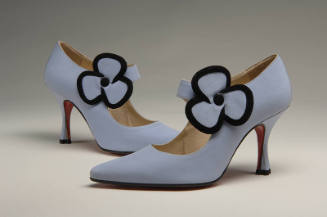 Pale purple high heel shoes with large flower at ankle strap lined in black