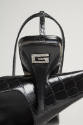 Detail of rhinestone G on back of black crocodile high heel