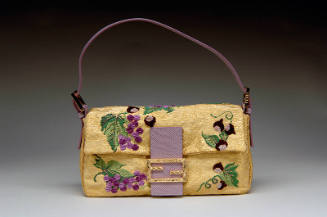 Gold bag embroidered with grapes and leaves, purple snakeskin closure with goldtone logo, purpl…