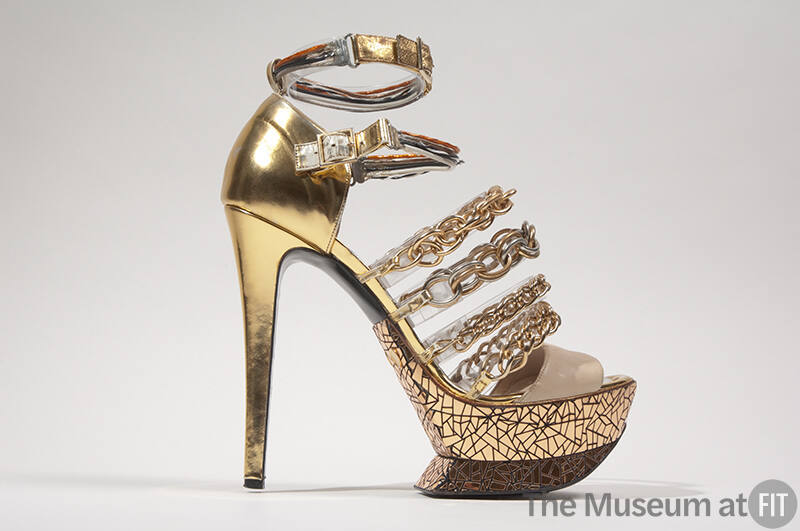 Metallic gold high heel sandal with mirrored platform sole, two wire ankle buckle straps and fo…