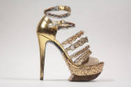Metallic gold high heel sandal with mirrored platform sole, two wire ankle buckle straps and fo…