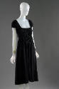 3/4 view of square neck black dress showing shirring at bodice