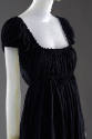 Detail view of black square neck dress showing shirring on bodice